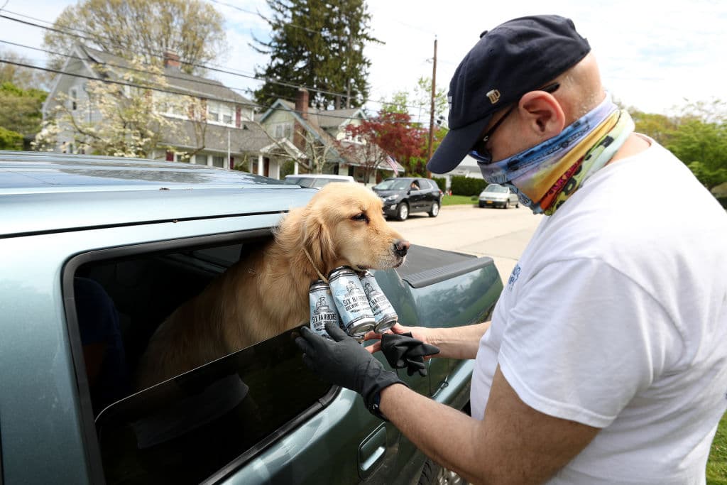 Los perros están equipados con un paquete de cuatro latas de cerveza vacías alrededor de sus cuellos (obvio no iban a llevar latas lenas, se iban a agitar todas).