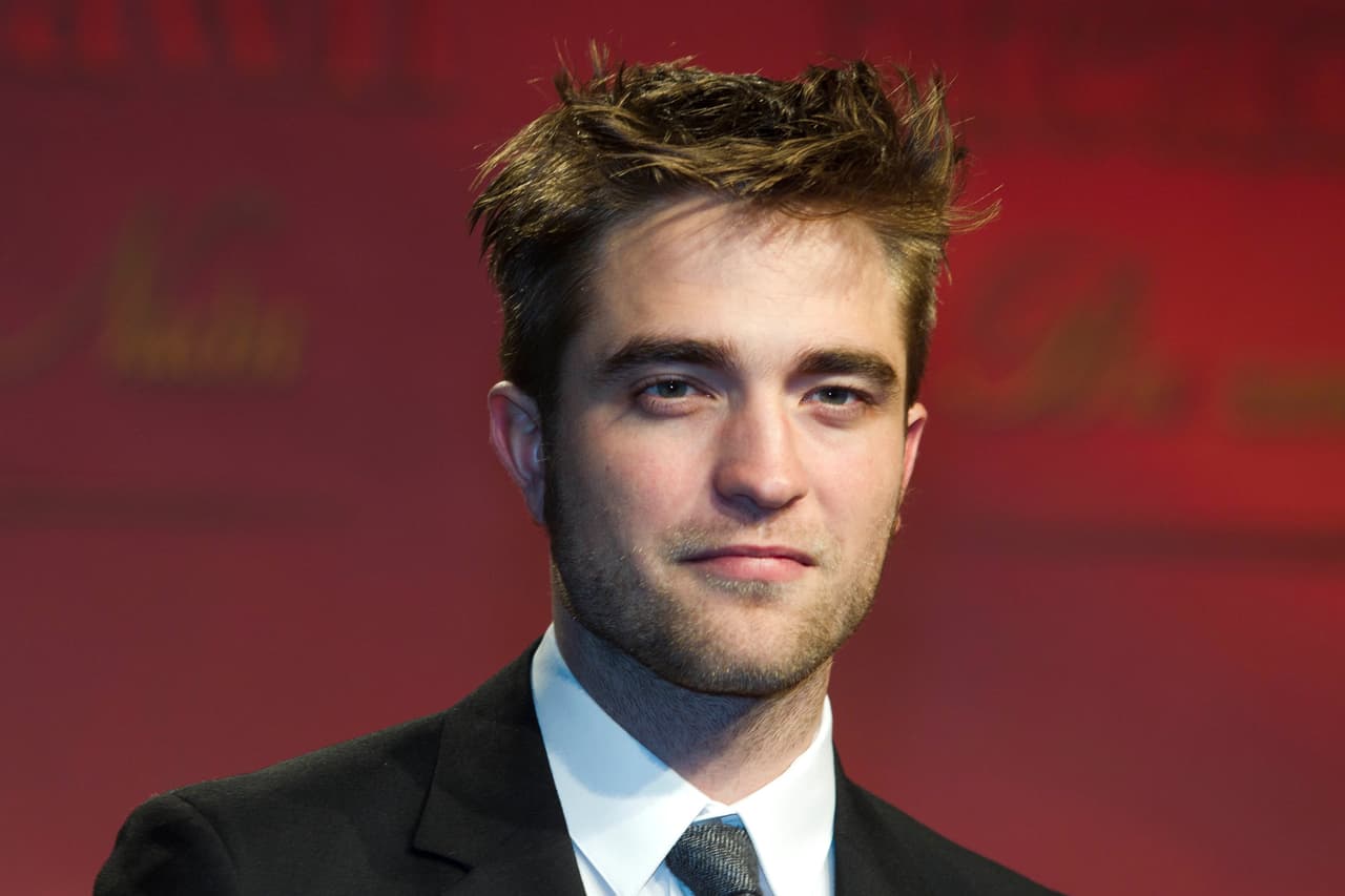 FILE, In this Nov. 18, 2011 file photo, British actor Robert Pattinson arrives at a film premiere of "Twilight Breaking Dawn Part 1" in Berlin. Pattinson has been out of sight since learning last month that his girlfriend and "Twilight" co-star Kristen Stewart had an affair with a married movie director. He is set to appear Monday night on "The Daily Show With Jon Stewart." It's a gentle re-entry into the media machine leading up to Friday's opening of his new movie "Cosmopolis." (AP Photo/Markus Schreiber, File)